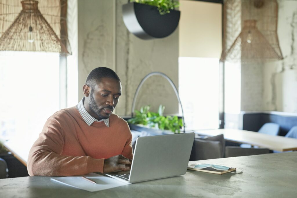 African Businessman Working in Cafe